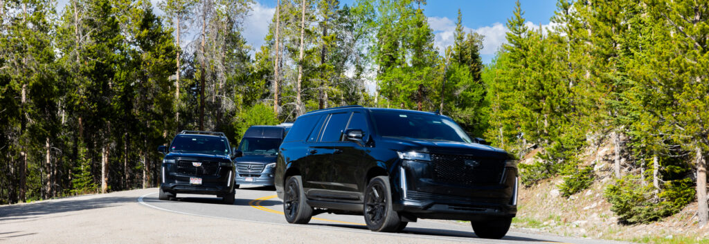 Cadillac Escalade chauffeured by Summit Black Car on Colorado mountain road